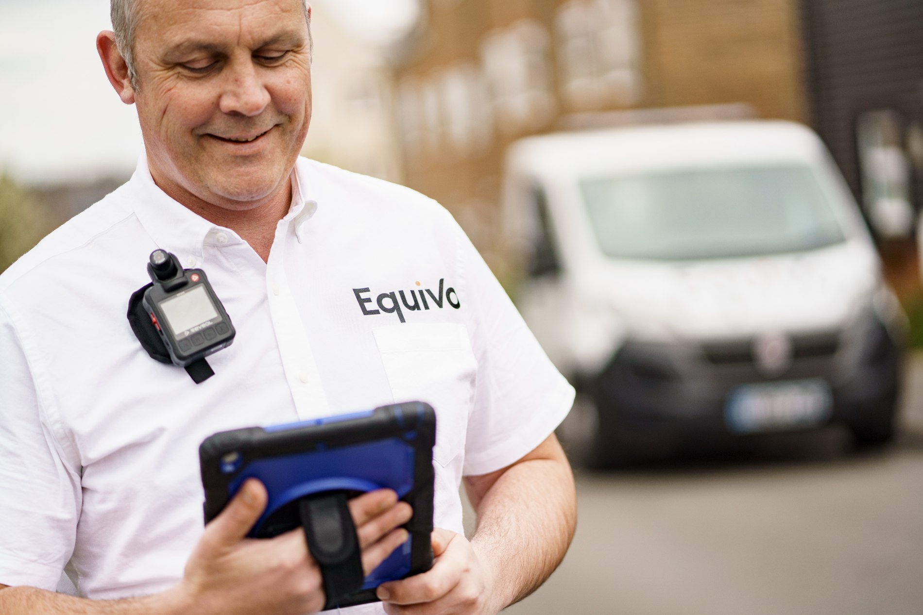 Certificated enforcement agent from Equivo with an iPad, carrying out a motor finance debt collection.