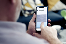 A man using the Equivo payment portal on a mobile phone to reduce arrears on his account